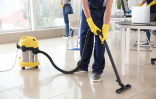 Janitor,Hoovering,Floor,In,Office
